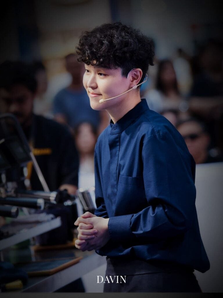 A portrait of Jane Kawinnart, Thailand's National Barista Champion, smiling at an event.