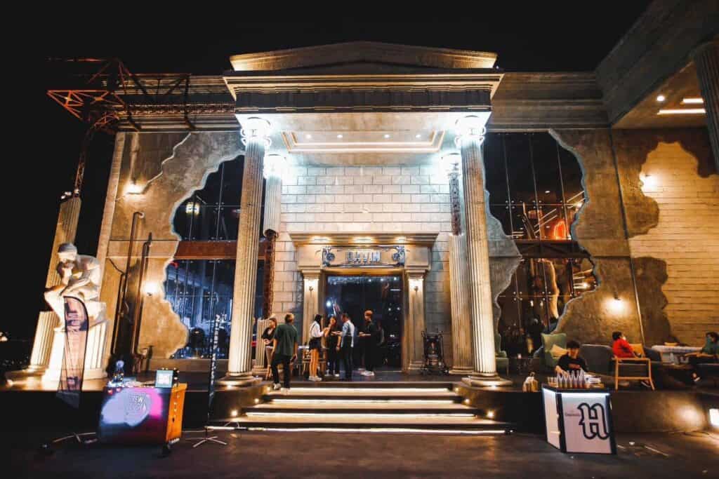 The grand nighttime entrance of a New Year event venue with elegant architectural design, welcoming guests into a premium year-end celebration space ideal for corporate parties, private gatherings, and upscale New Year events