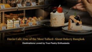A signature cake being served in front of Davin Cafe’s curated pastry showcase, highlighting its reputation as a premium bakery Bangkok destination known for refined flavors, elegant presentation, and memorable dessert experiences.