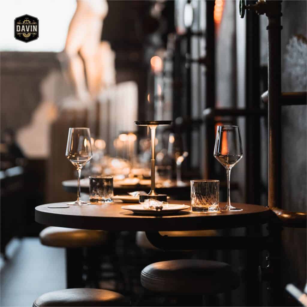 Candlelight dining table with wine glasses prepared for an intimate first date, creating a warm and romantic restaurant atmosphere