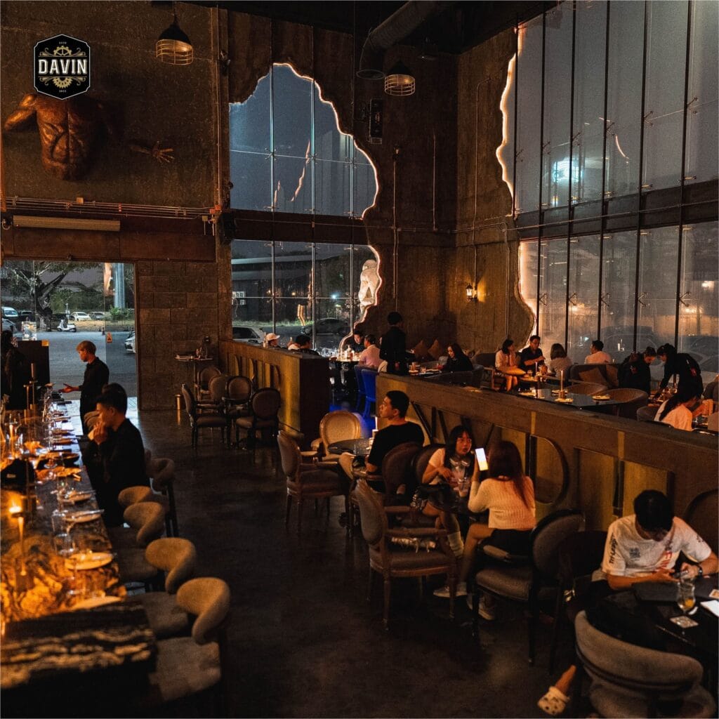 Romantic restaurant interior at night with warm lighting and couples dining, an ideal venue atmosphere for a memorable first date in Bangkok