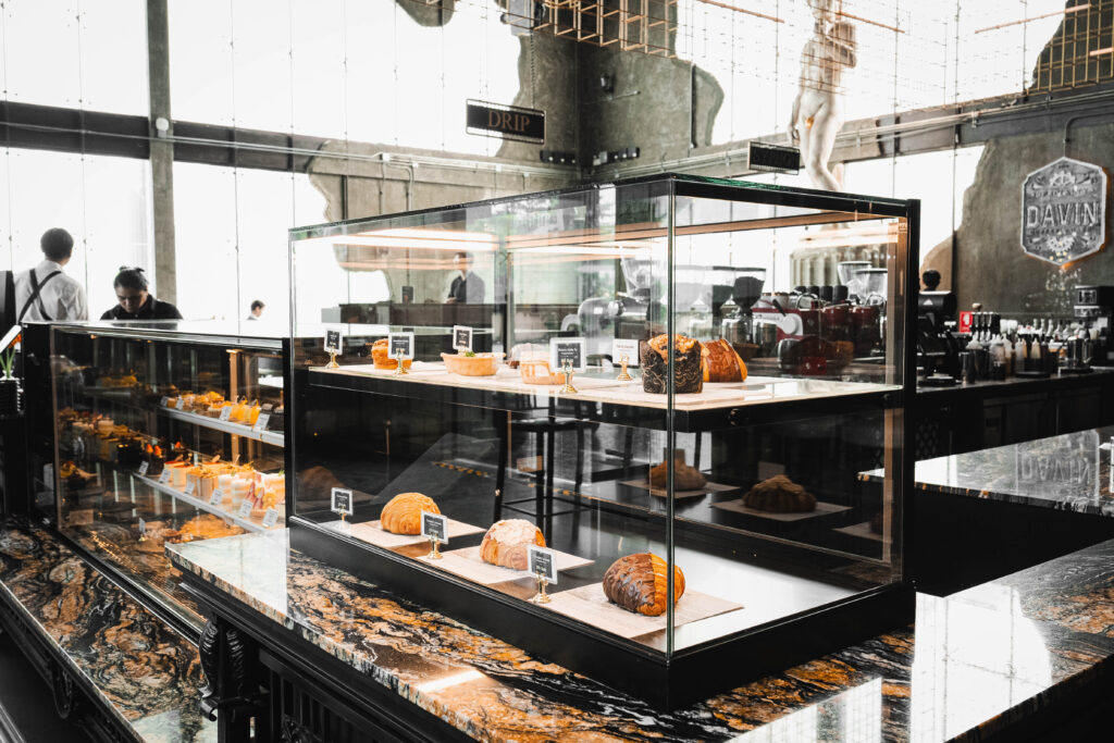 A premium bakery display at Davin Cafe featuring curated pastries on a marble counter, ideal for seminar catering and enhancing the overall event experience in Bangkok