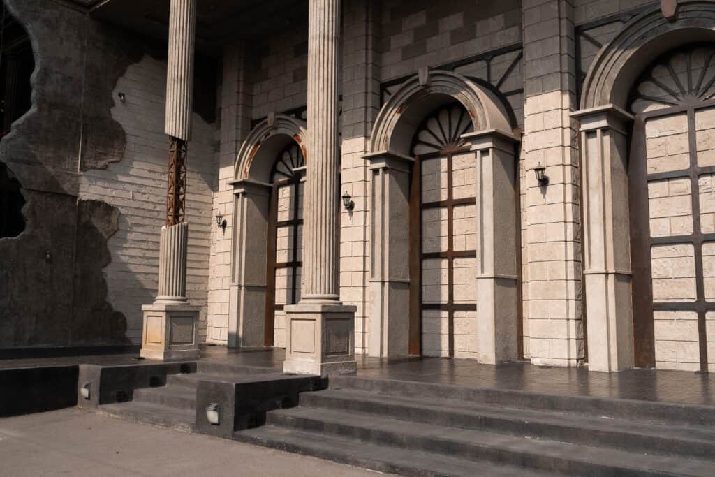 The exterior façade of Davin Cafe featuring arched doorways and classical columns, evoking a European architectural style and offering a refined, photo-friendly café setting in Bangkok
