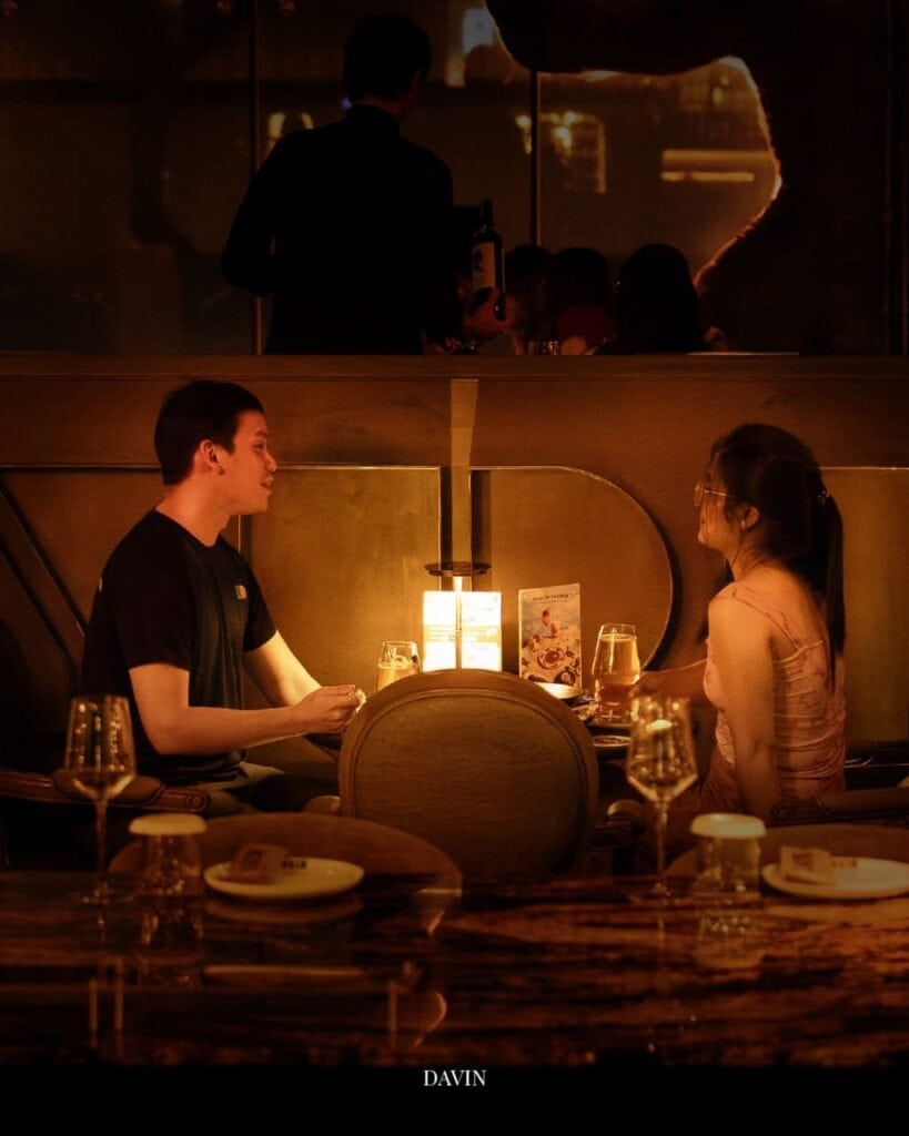 Couple enjoying a candlelight dinner at DAVIN CAFE, a good atmosphere dinner spot with warm romantic lighting, perfect for date nights and intimate evening dining experiences