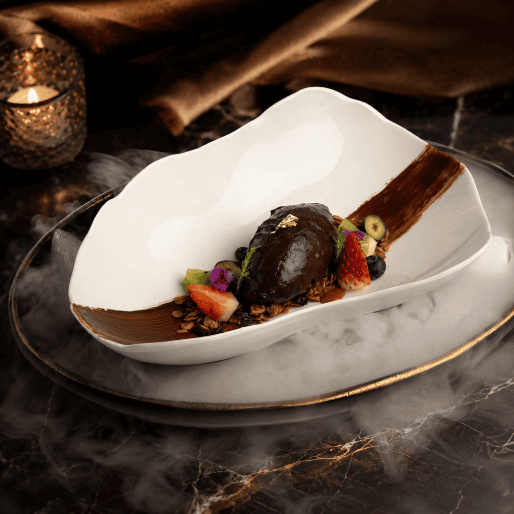 Dark chocolate plated dessert at Davin Cafe with fresh berries, granola, and a dramatic smoke presentation, highlighting a premium cake shop and dessert cafe experience on Liab Duan Road for chocolate and sweet lovers.
