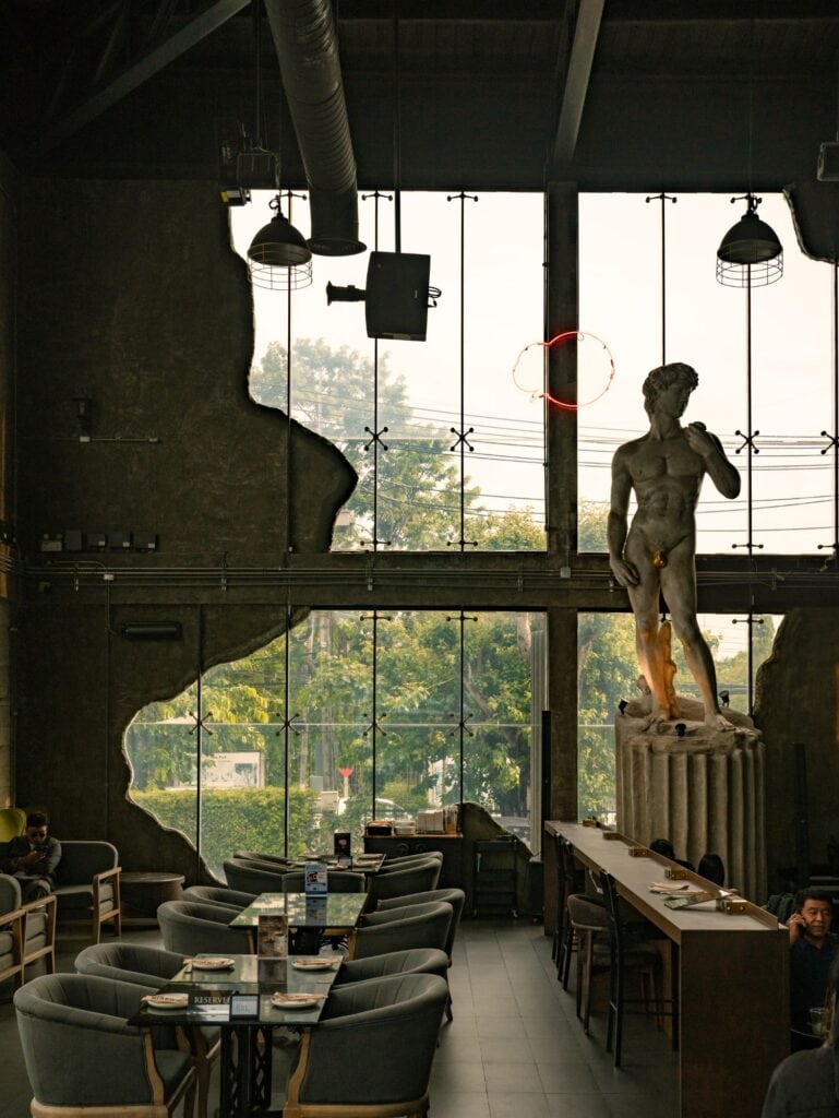 Window-side seating at DAVIN CAFE, a rainy day cafe in Ramintra with spacious interiors and European-inspired decor