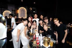 A group of fans smiling for a photo while enjoying drinks together at our atmospheric fan meeting venue in Bangkok.