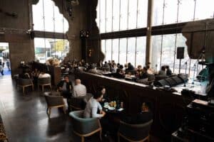 Attendees enjoying food and networking in the spacious hall of our versatile corporate party venue in Bangkok.