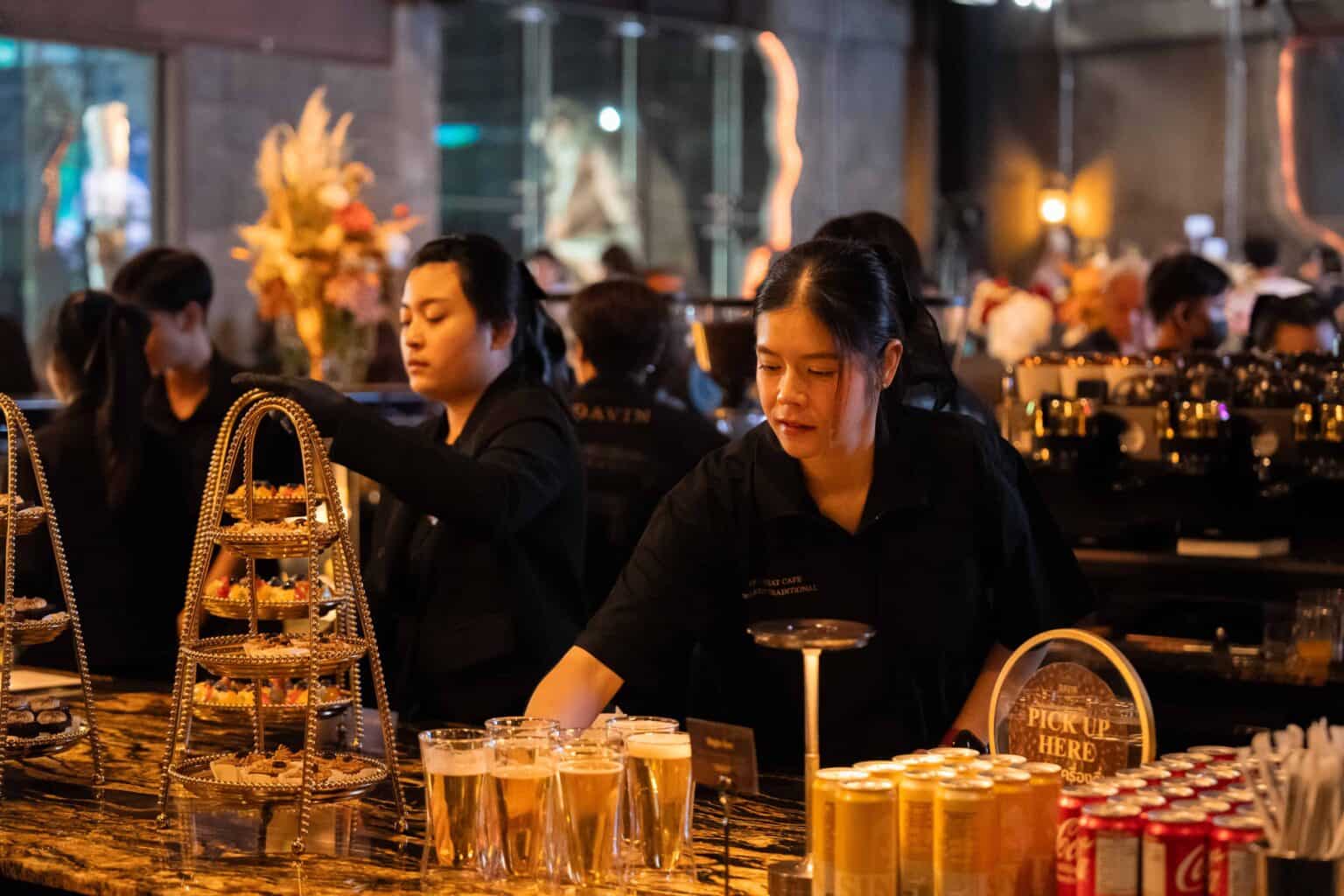 Professional catering staff preparing drinks and desserts for an event at Davin Cafe, a premium corporate party venue in Bangkok.