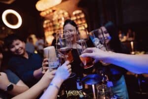 Guests raising glasses during a corporate product launch celebration at Davin Cafe in Bangkok