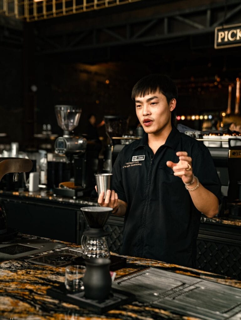 DAVIN CAFE, a European-style cafe in Bangkok, with a barista carefully preparing pour-over coffee