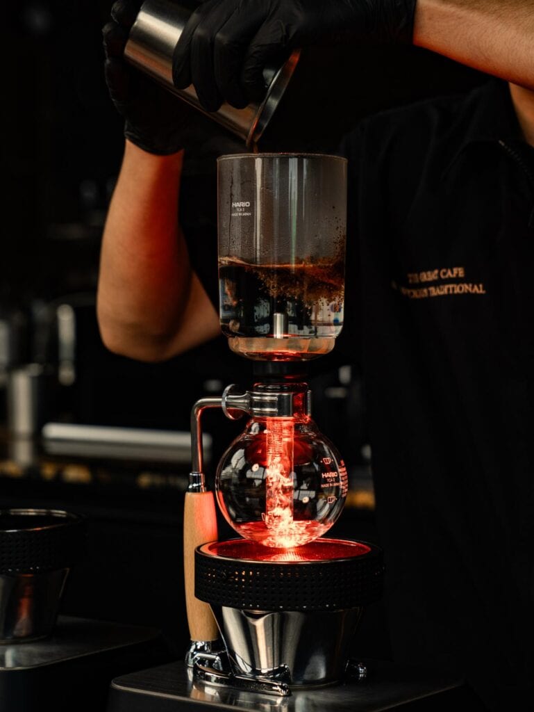 DAVIN CAFE specialty coffee shop in Bangkok, with a barista carefully preparing pour-over coffee