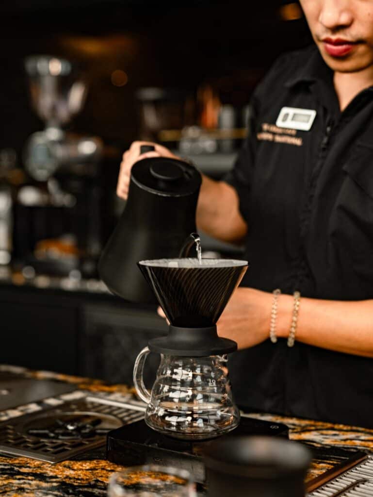 European-style cafe in Bangkok featuring a barista preparing Pour Over coffee at DAVIN CAFE