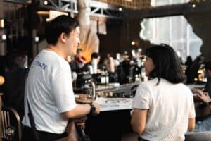 Attendees networking at the stylish coffee bar inside Davin Cafe, a unique and welcoming event space rental in Bangkok.