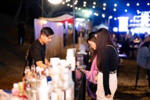 Guests visiting an exhibition booth during an outdoor event at Davin Cafe in Bangkok