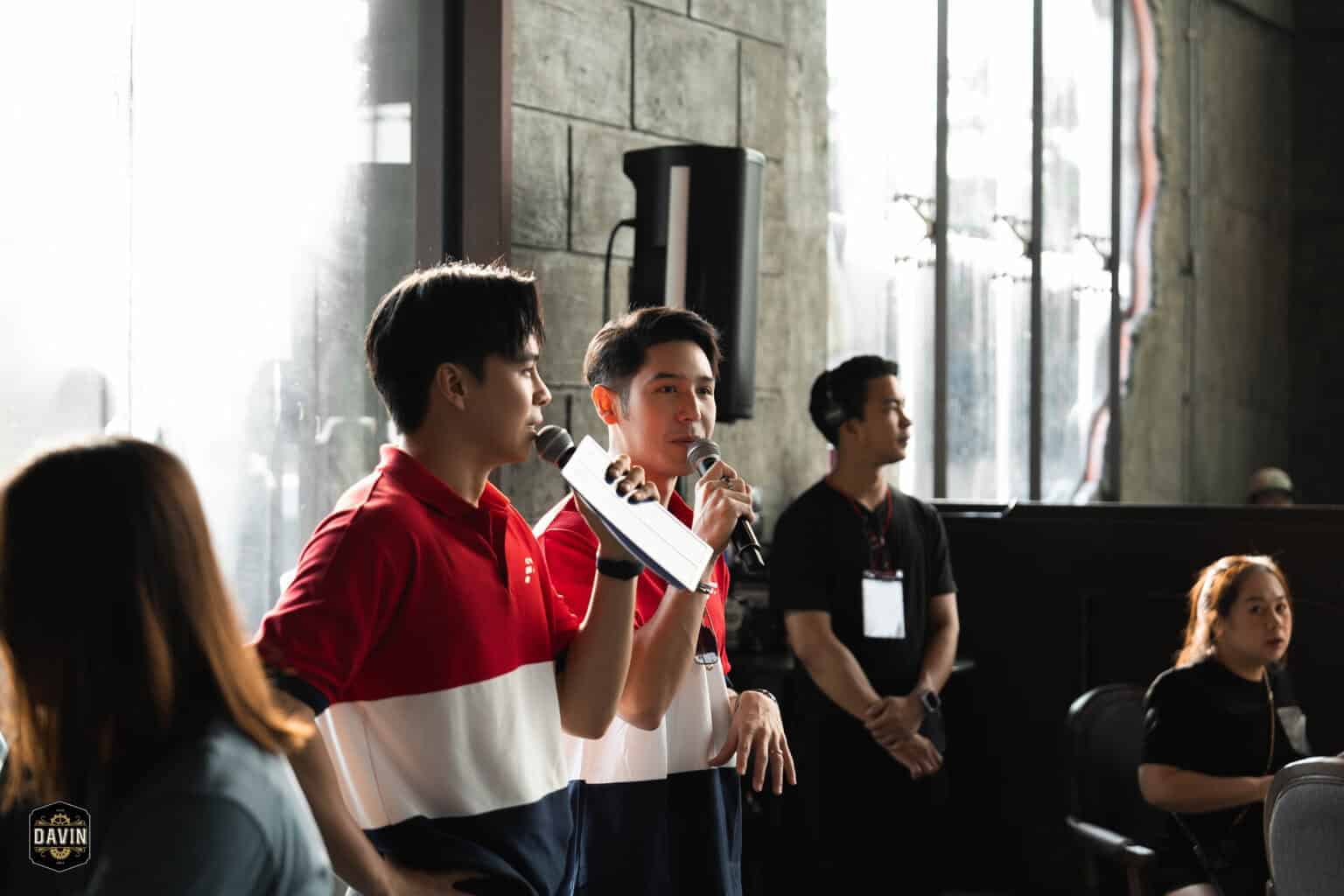 Two male guest speakers talking into microphones during an interactive session at a seminar venue in Bangkok.