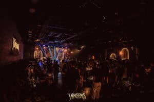 A crowd of fans enjoying a live band performance at Vinsens, a uniquely themed fan meeting venue in Bangkok.