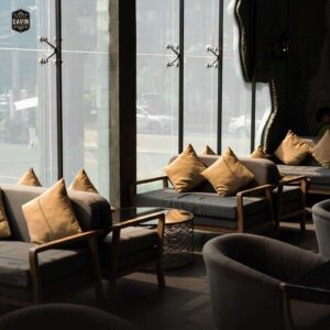 Comfortable lounge seating with grey armchairs and natural sunlight in the private breakout space of a seminar venue in Bangkok.