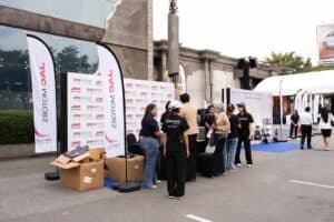 Event staff preparing the registration area for a product launch at Davin Cafe in Bangkok