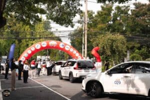 Cars lining up at the starting arch for a rally, utilizing the spacious outdoor event space rental in Bangkok at Davin Cafe.