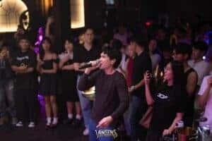 A singer performing up close with the excited crowd, highlighting the intimate and engaging atmosphere of this fan meeting venue in Bangkok.