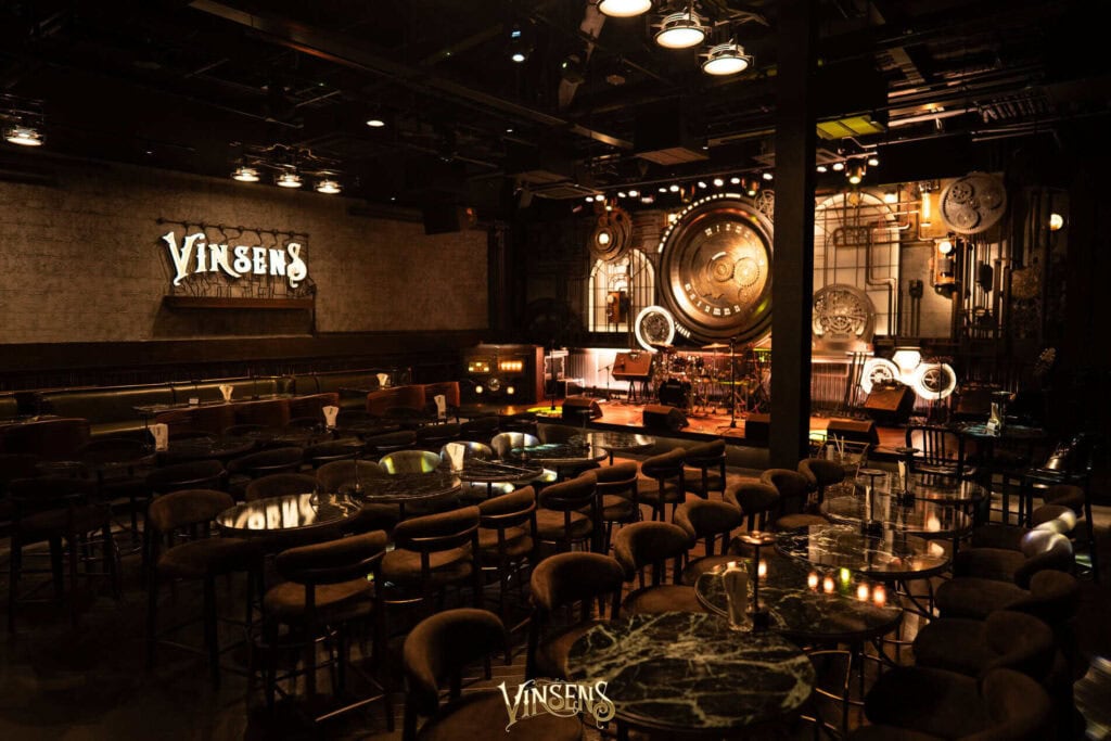 The unique steampunk-themed stage and cozy seating layout at Vinsens, an ideal fan meeting venue in Bangkok.